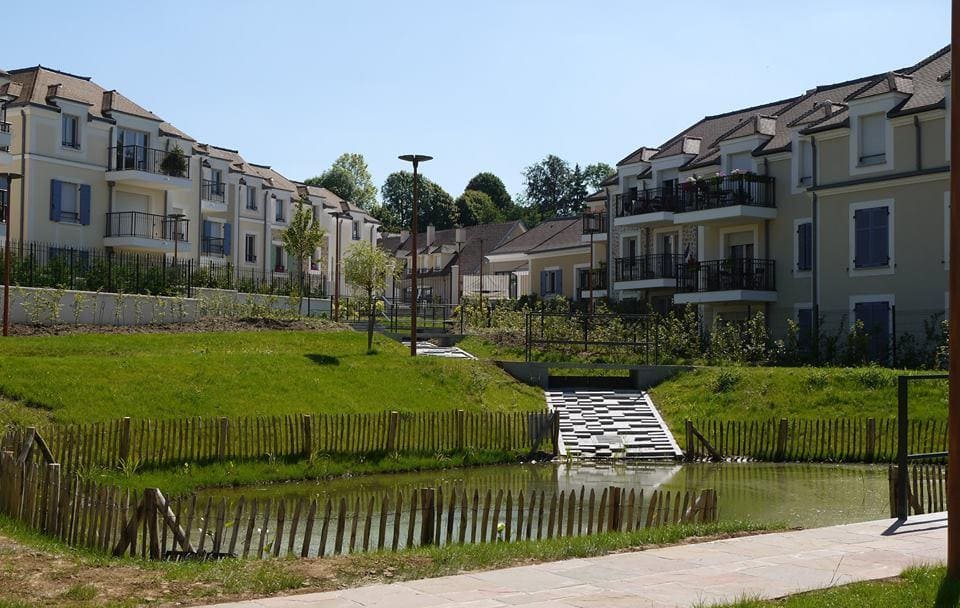 Photo de plusieurs batiment à Fourqueux avec un petit espace vert